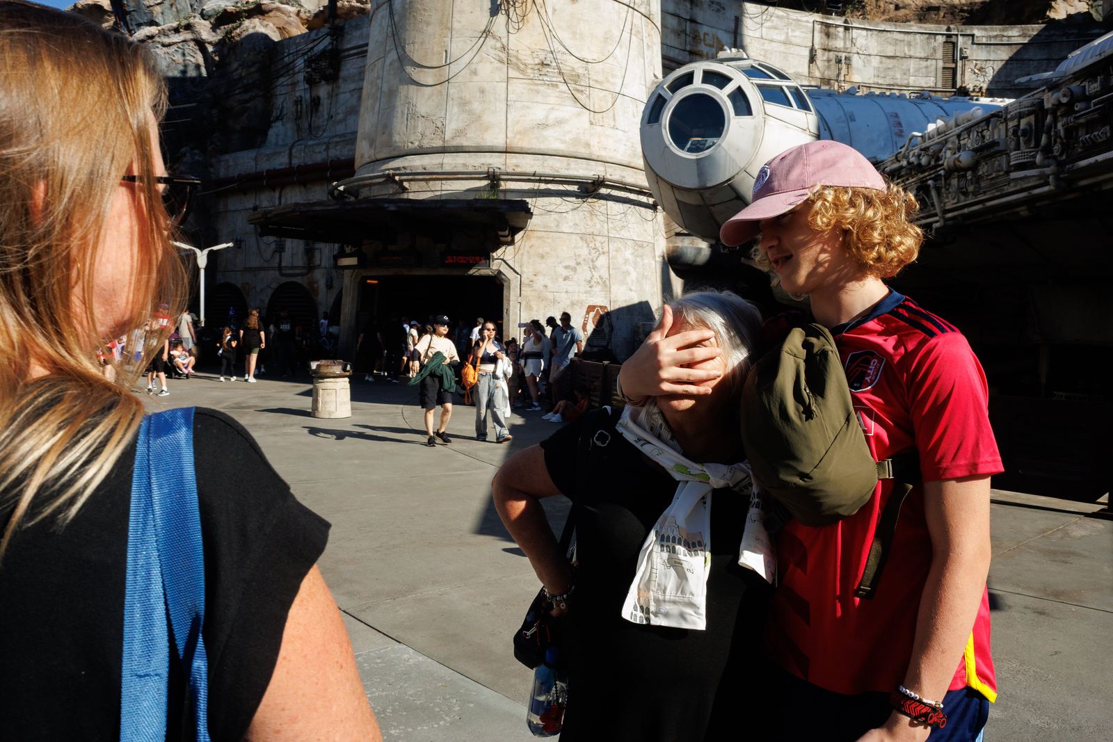 A young man embracing an older woman in a crowd