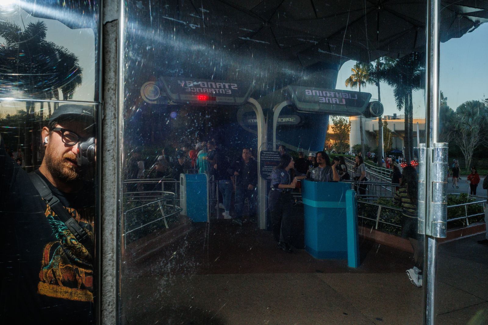 A man and a crowd layered in blue-toned glass reflections
