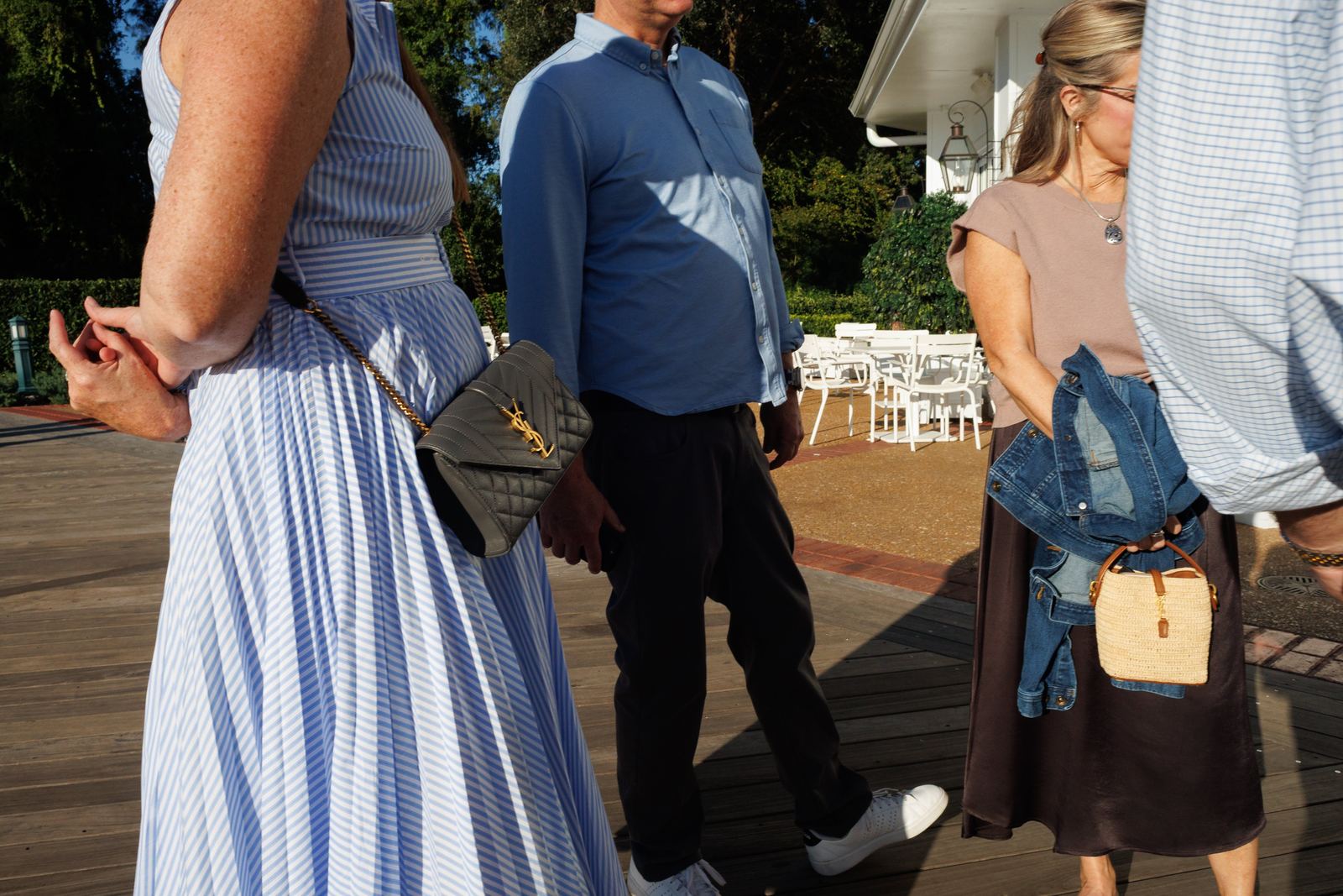 Passing figures and blue stripes in late sunlight